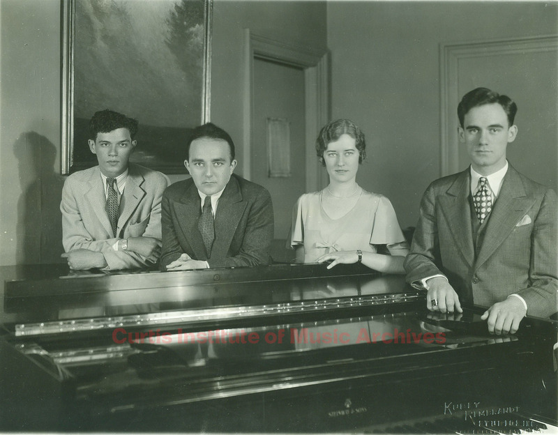 Harry Kaufmann and students around a piano
